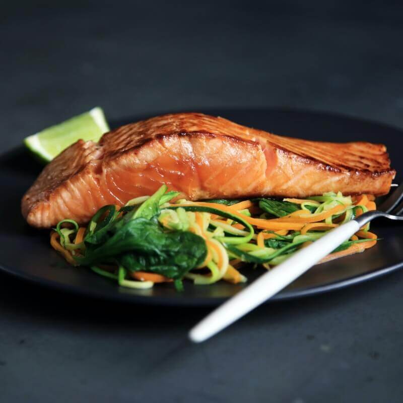 Perfectly cooked salmon over greens